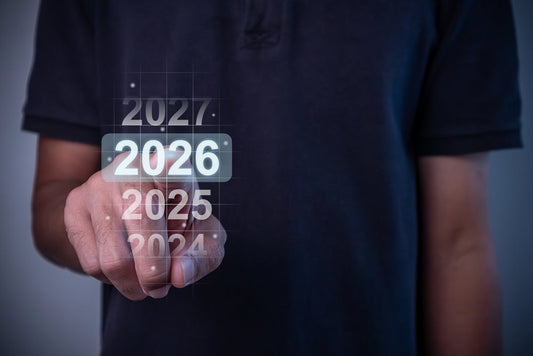 Person pressing highlighted "2026" button on a translucent virtual year selector, set against a dark neutral background.